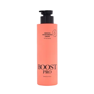 A bottle of Boost Pro Keratin Moisturizing Cream, featuring a sleek design in coral color with a pump top.